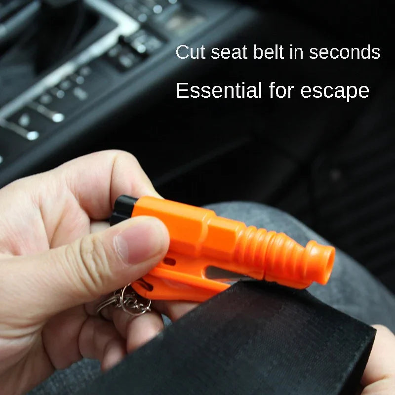 Hand holding orange emergency seat belt cutter keychain in car, essential for escape, Voltaxa