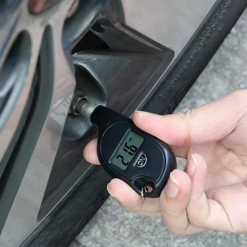 Digital tire pressure gauge checking car wheel, Voltaxa automotive accessory