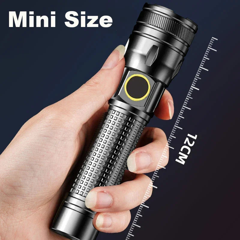 Hand holding compact black flashlight, 12cm mini size, Voltaxa portable torch