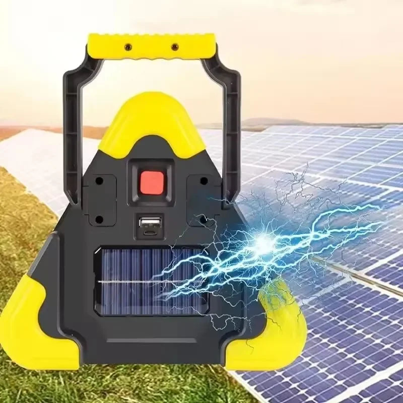 Yellow and black portable solar generator by Voltaxa on solar panel field, energy sparks visible.