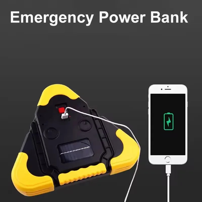 Voltaxa yellow and black emergency solar power bank charging a smartphone