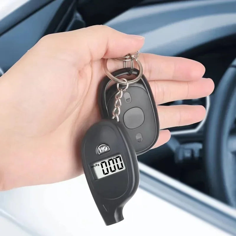 Hand holding Voltaxa keychain digital breathalyzer and car key fob near car steering wheel